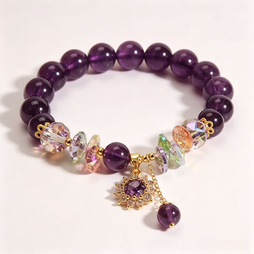 Amethyst bead bracelet with rainbow crystal accents, a gold-tone flower charm and a dangling purple bead.