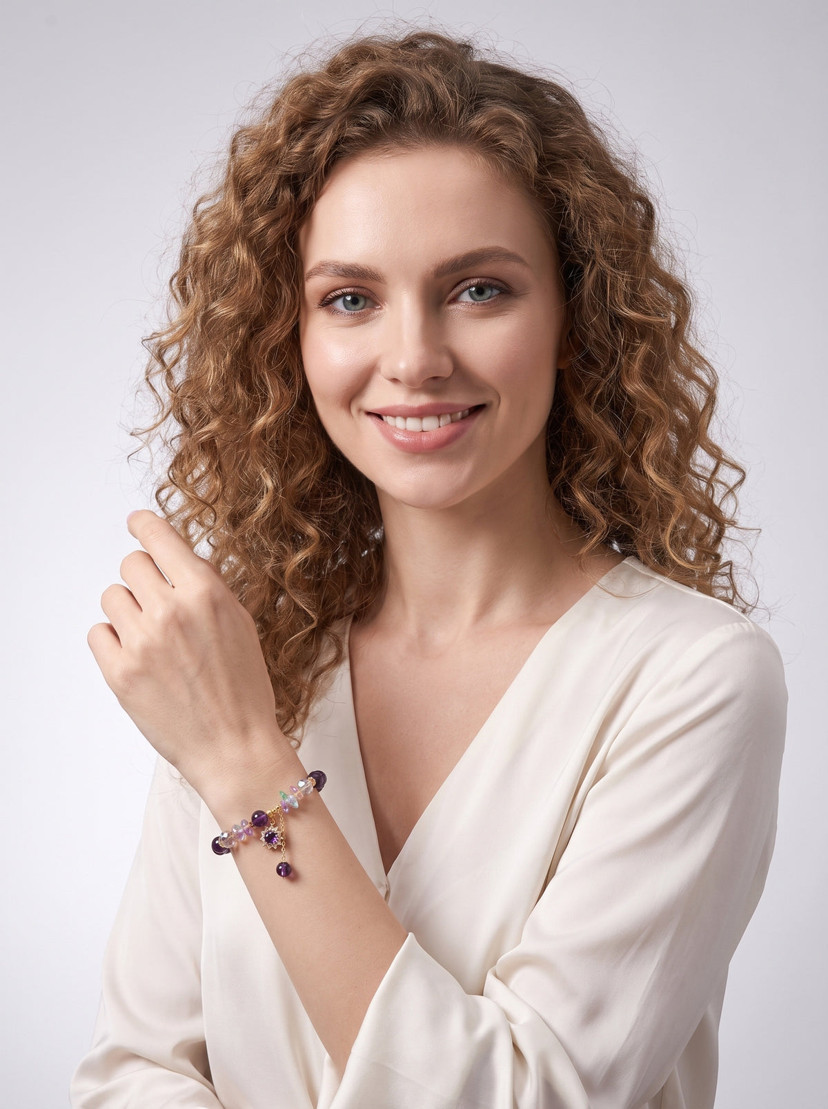 Model wearing an amethyst flower charm bracelet with a white blouse.
